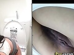 A Asian slut with nice huge tits is spied on while taking a piss in public toilet